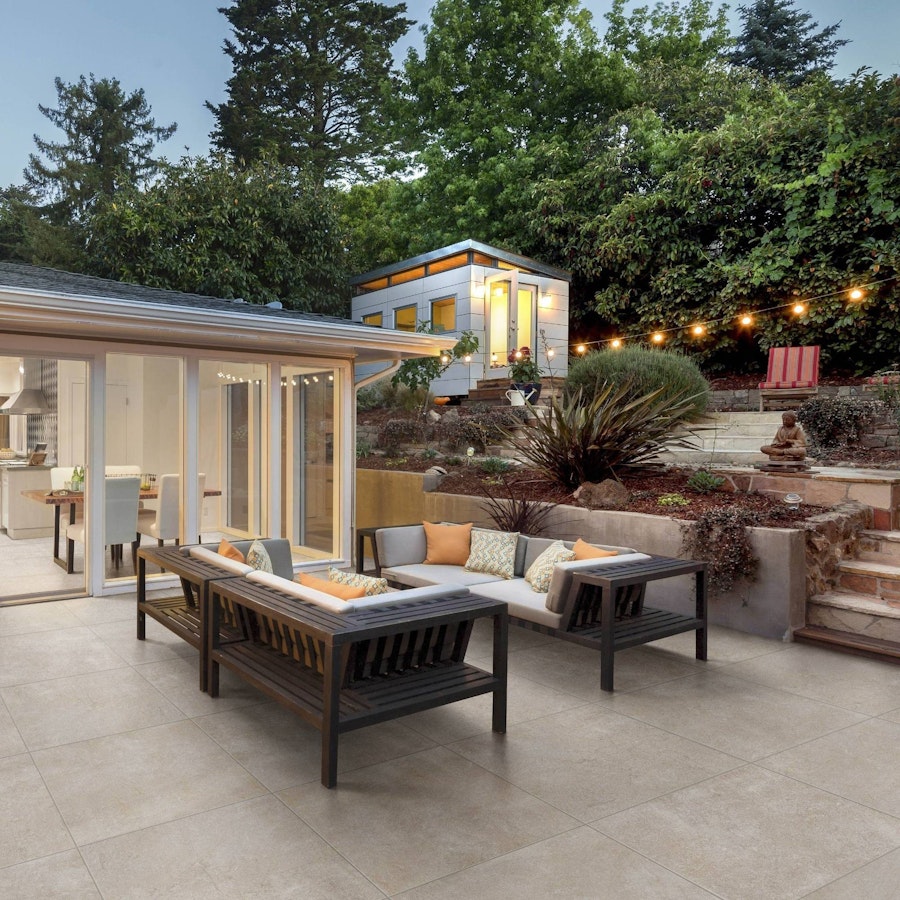 Patio at sunset, with garden furniture and lights to create a cosy atmosphere