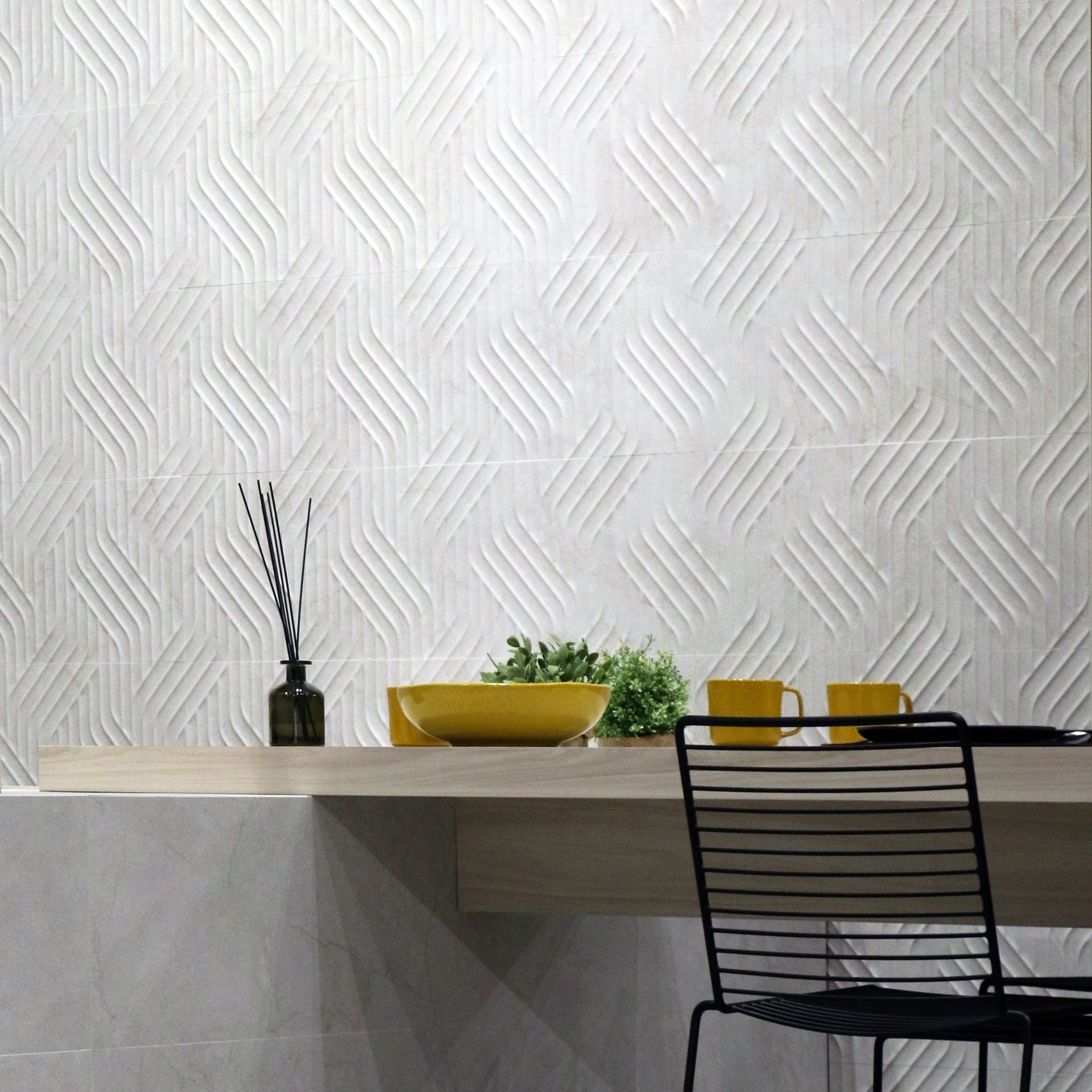 Modern kitchen with Pensford white wave geometric wall tiles and a black chair.