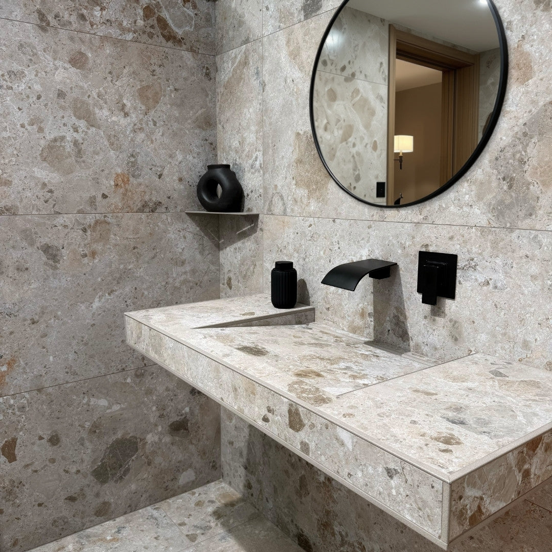 Bathroom with marble vanity, sink, and round mirror.

layout-bathroom