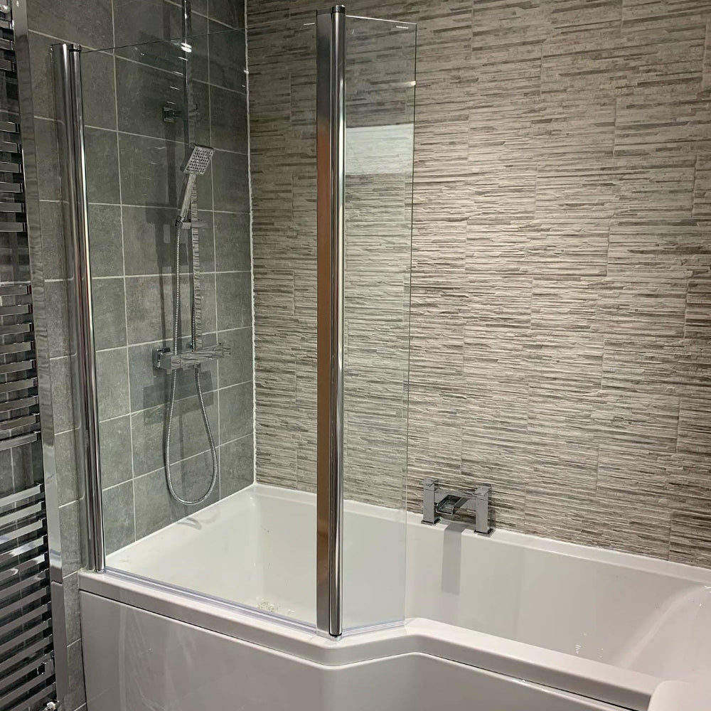 Modern bathroom with a corner shower and tiled walls.