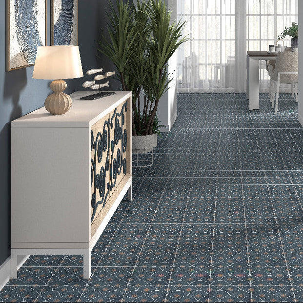 Modern interior with a blue patterned tiled floor, white furniture, and large windows.