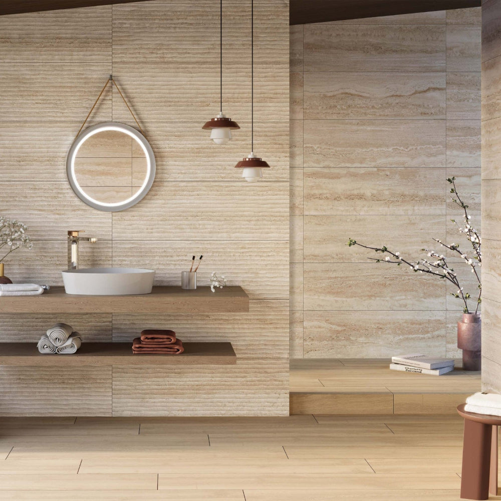Modern bathroom with wooden vanity, round mirror, and decorative elements on sunstone waved decor and stone effect wall tiles.