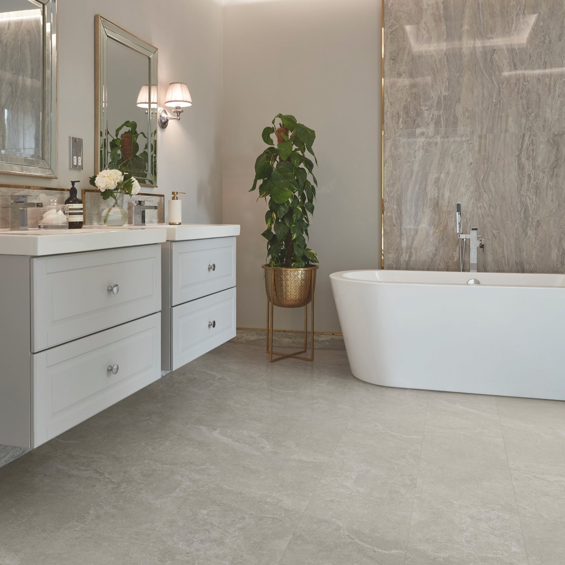 Modern bathroom with white vanity, freestanding bathtub, and decorative plant on lvt travertine stone-look grey tiles

layout-bathroom