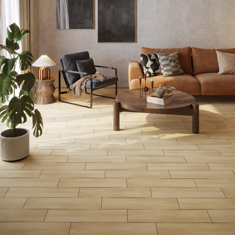 Modern living room with a wood-effect tile floor, sofa, coffee table, and wall art.