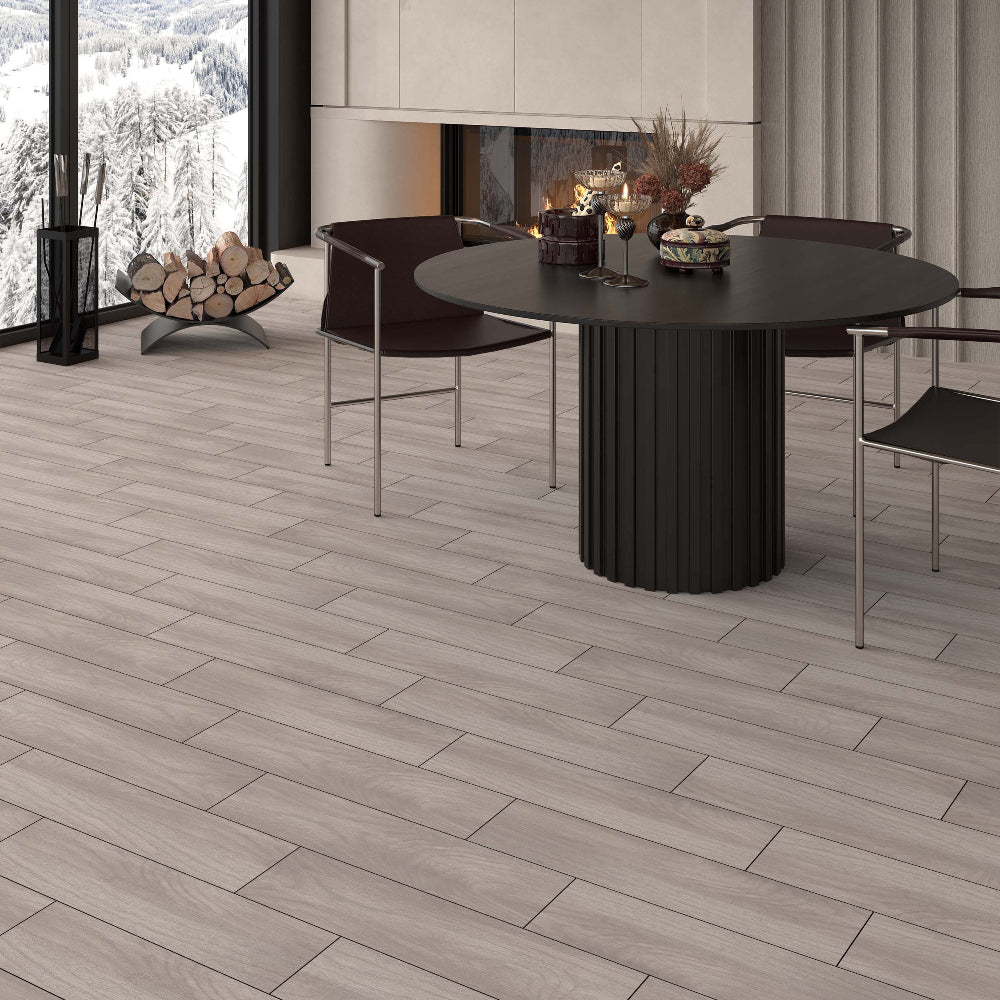 Modern dining area with a black round table and chairs in a room with large windows, a fireplace and wood-effect tiled floor.