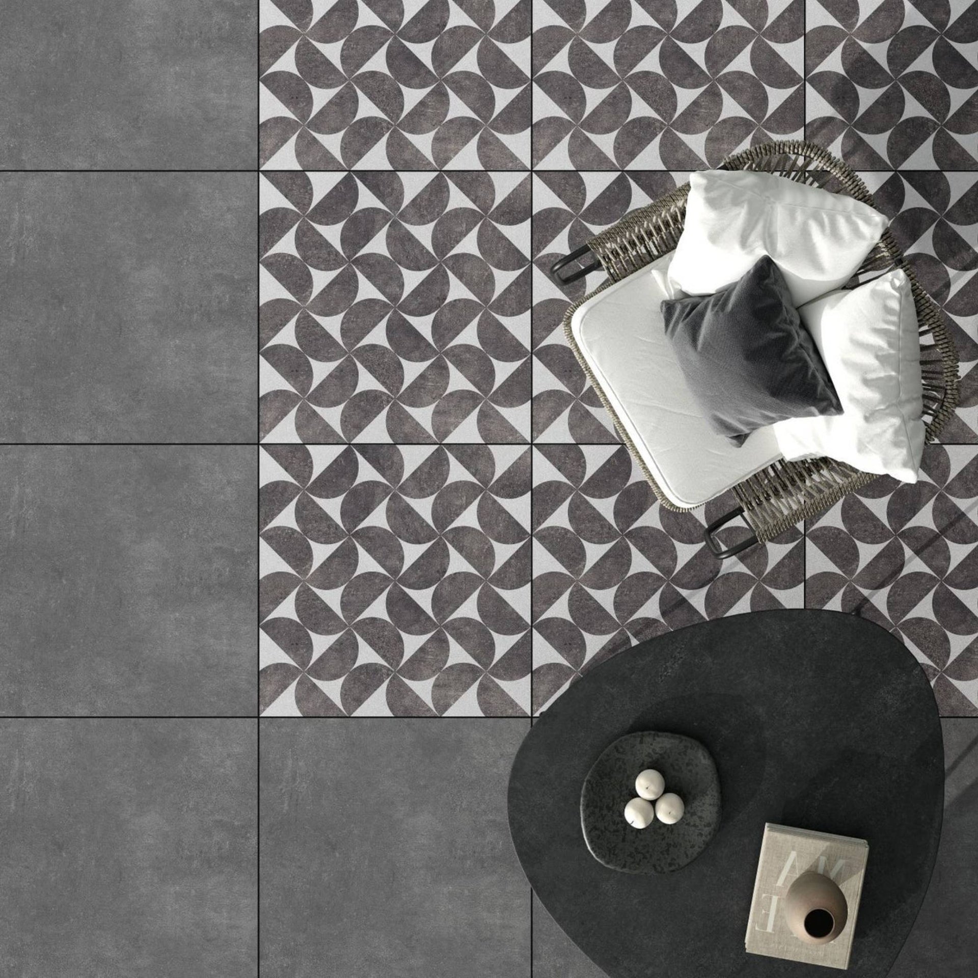 Bodrum eclipse grey geometric patterned tiles with a modern chair and decor items on a patio