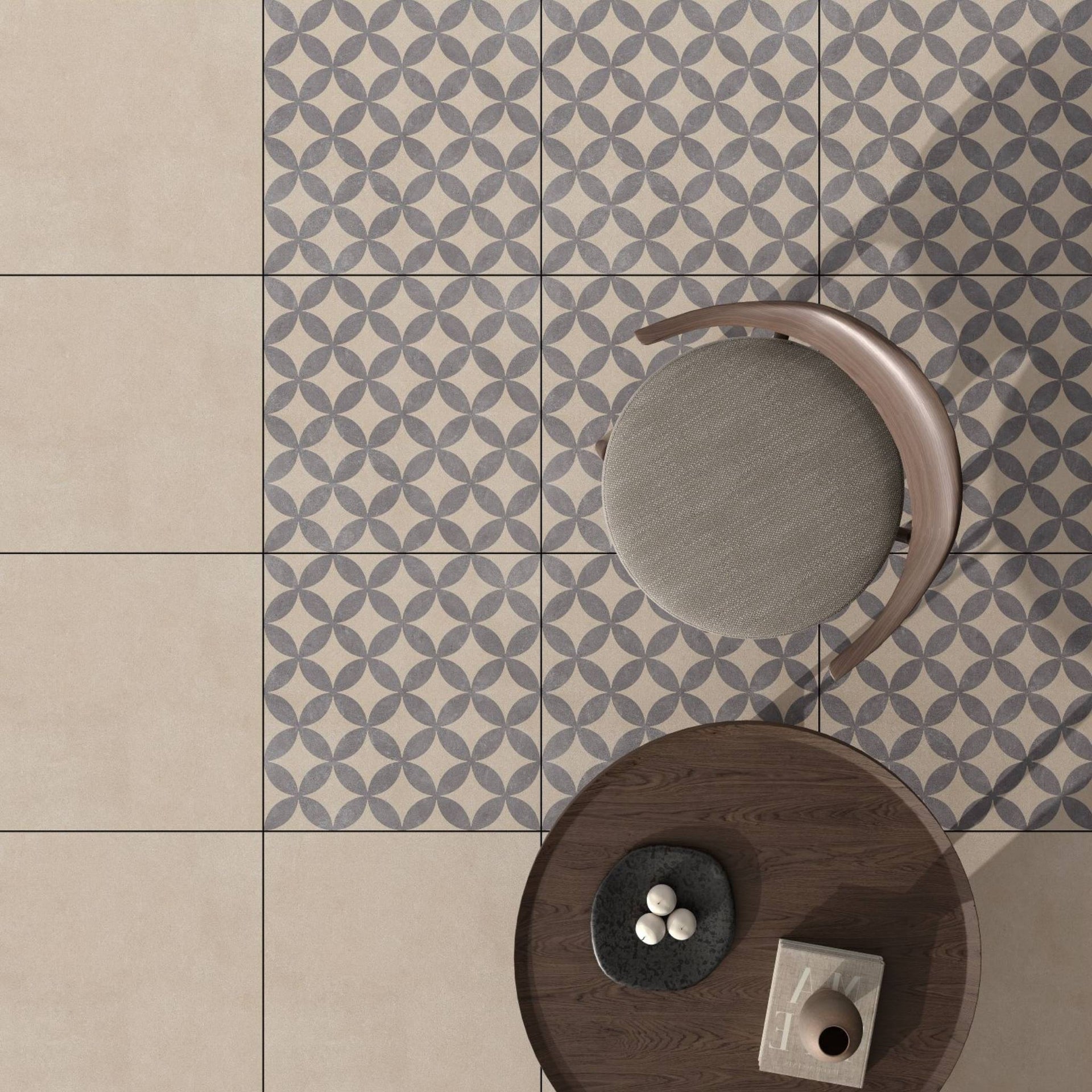 outdoor patio with Bodrum flower beige grey geometric patterned tiles, featuring a modern chair and decor items