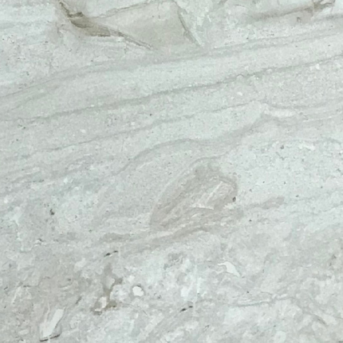 A white wall tile with a marble effect texture.