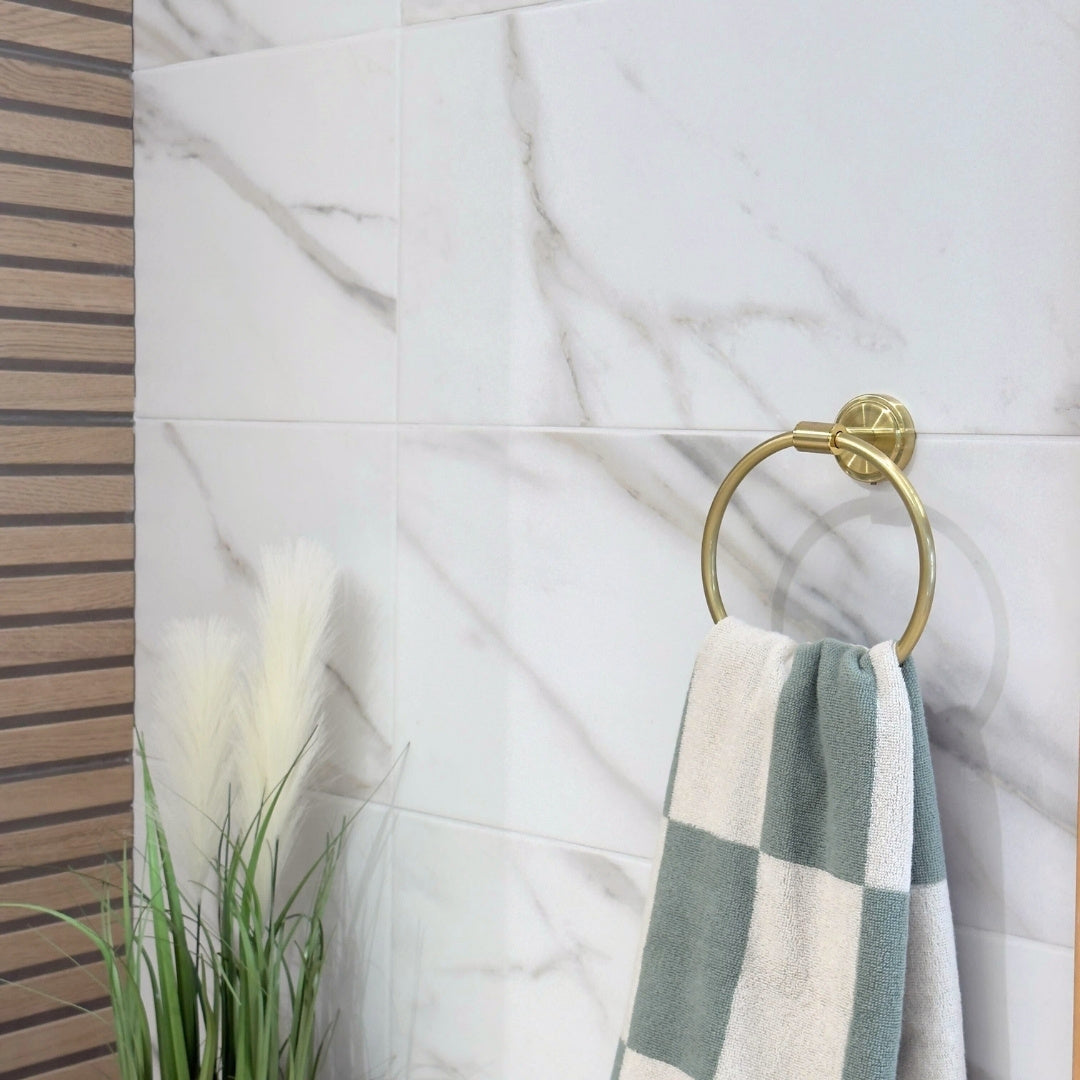 Elmore white marble effect wall tiles on a bathroom with plants and gold accents