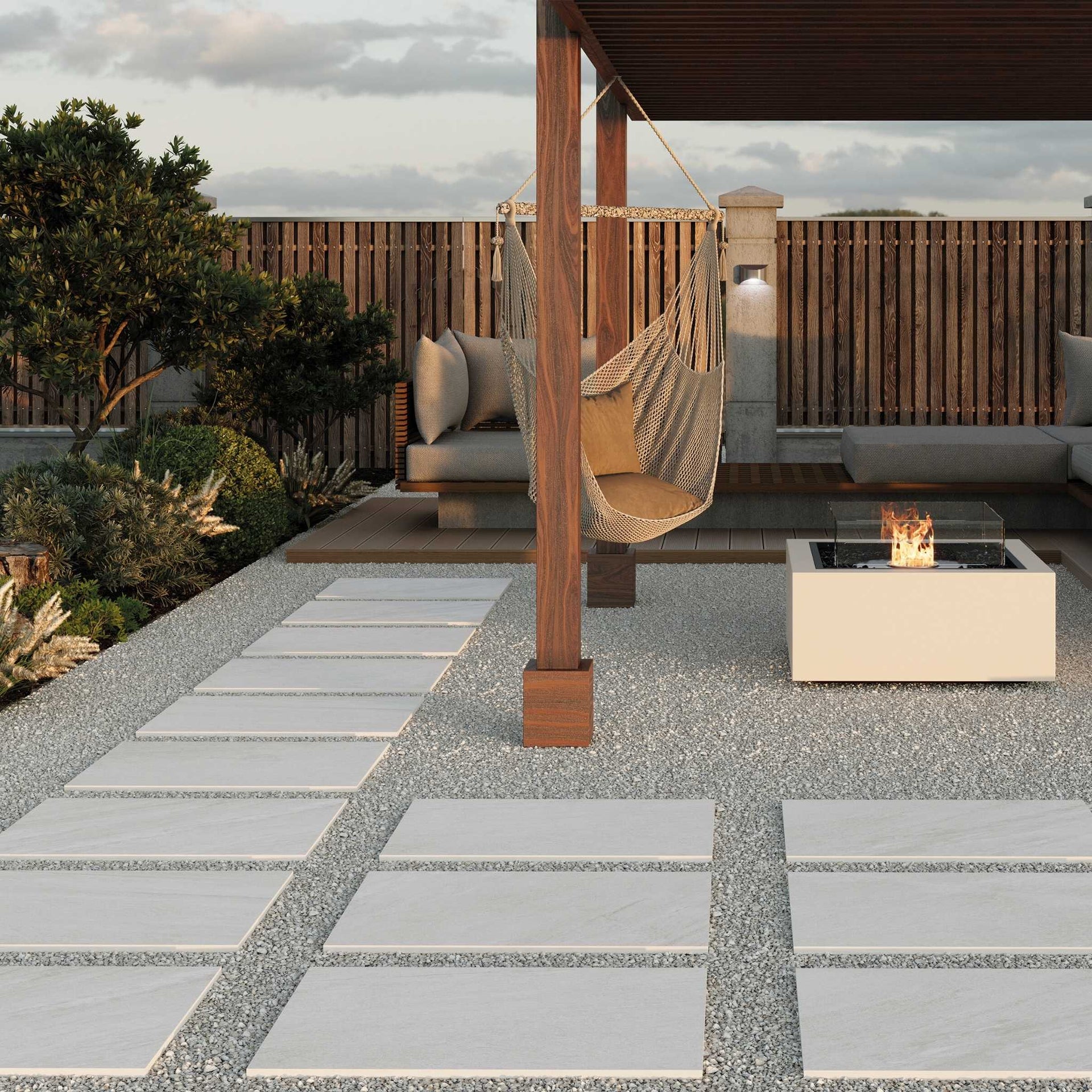 Outdoor patio with a fire pit, hammock, and Napton white stone-effect tile pathway.