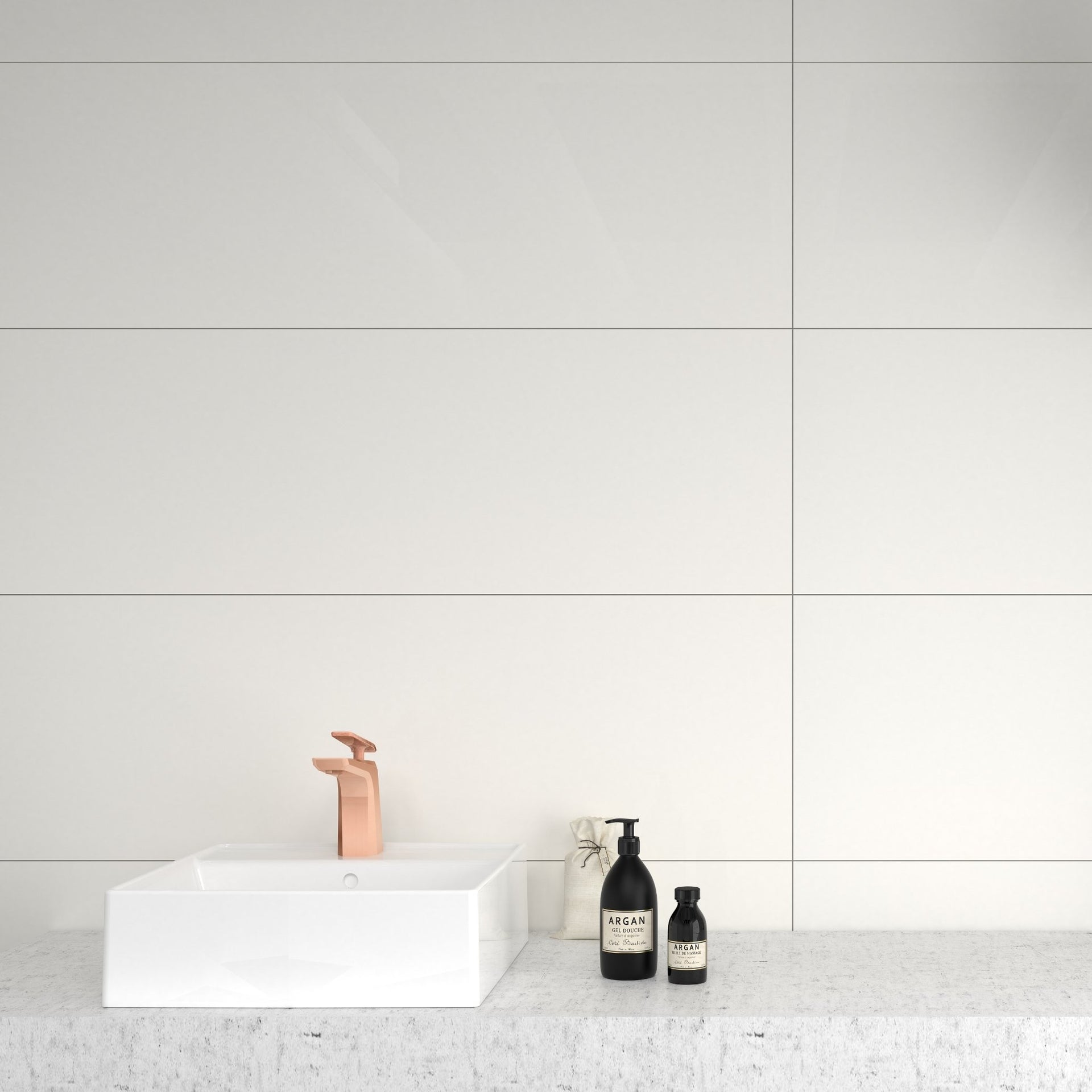 Bathroom setting with a white sink and two black bottles on a light gray countertop against a large white new blancos tiled wall.