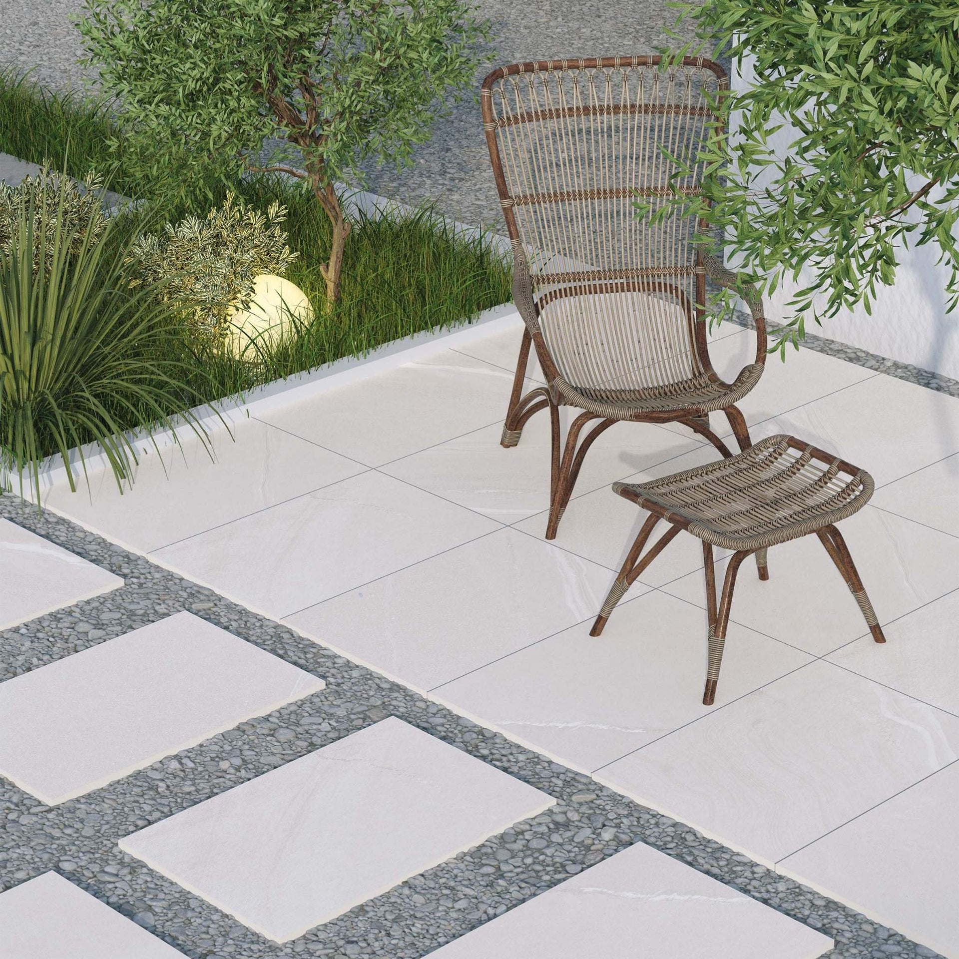 Wicker chair and ottoman on a tiled otis grey stone effect patio with plants