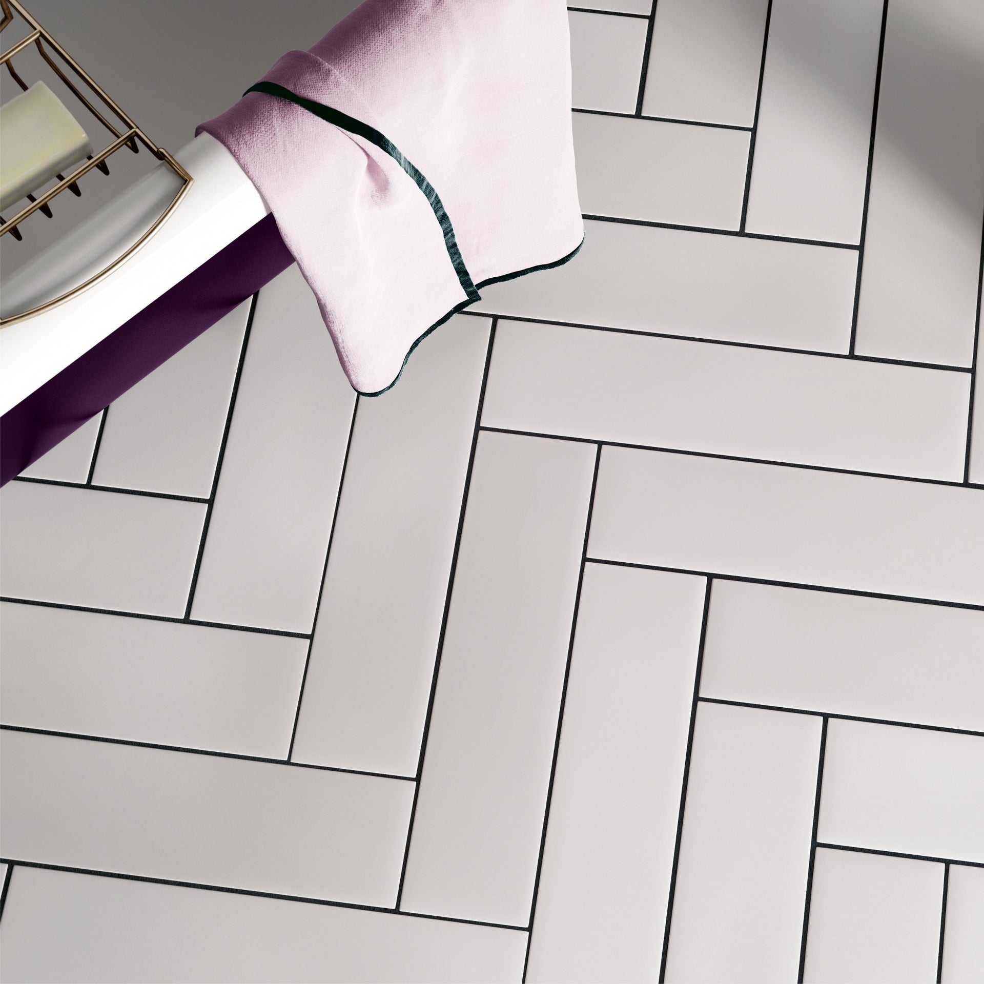white matt herringbone floor tiles in a bathroom setting