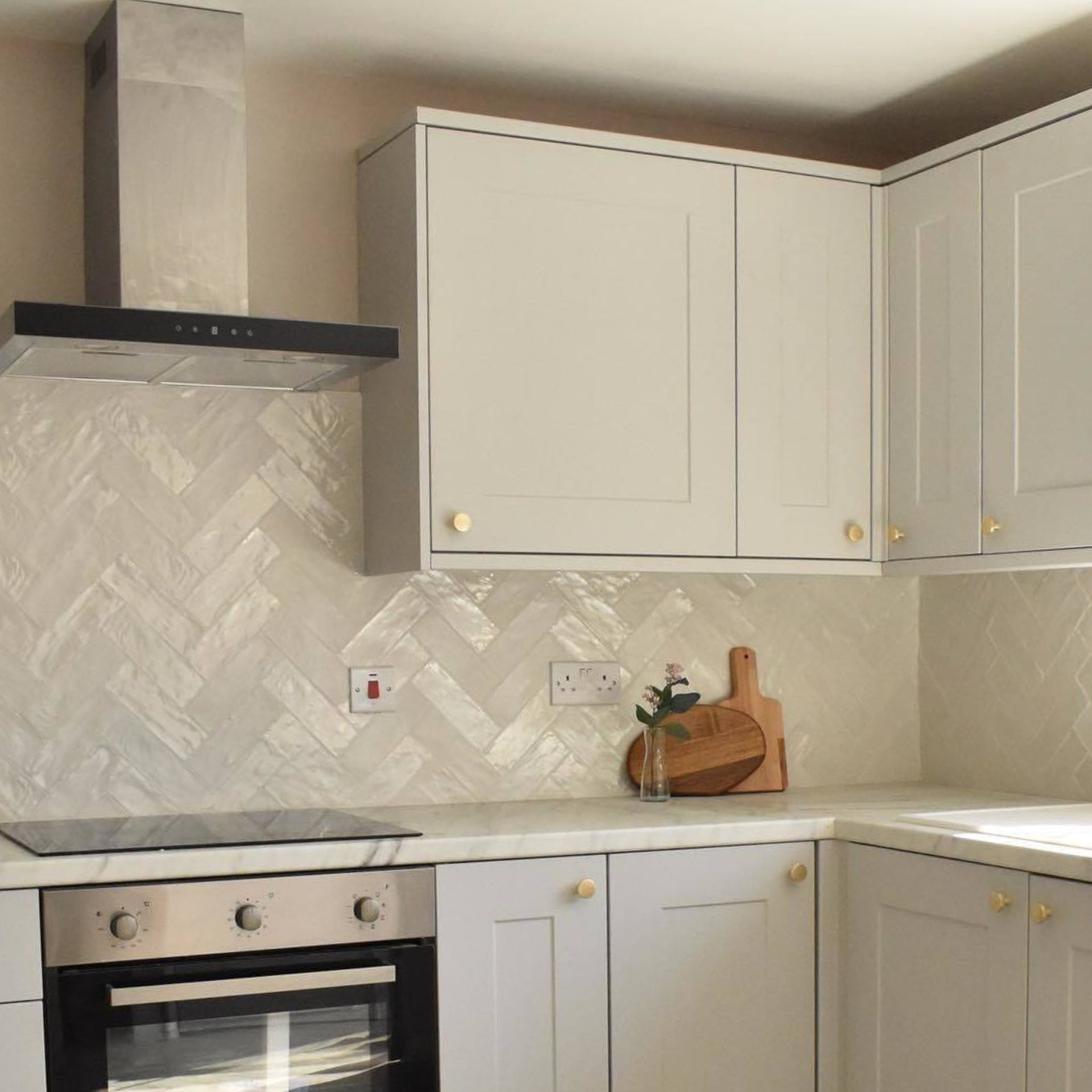 shimmer gloss white wall tiles in herringbone layout on a modern white kitchen