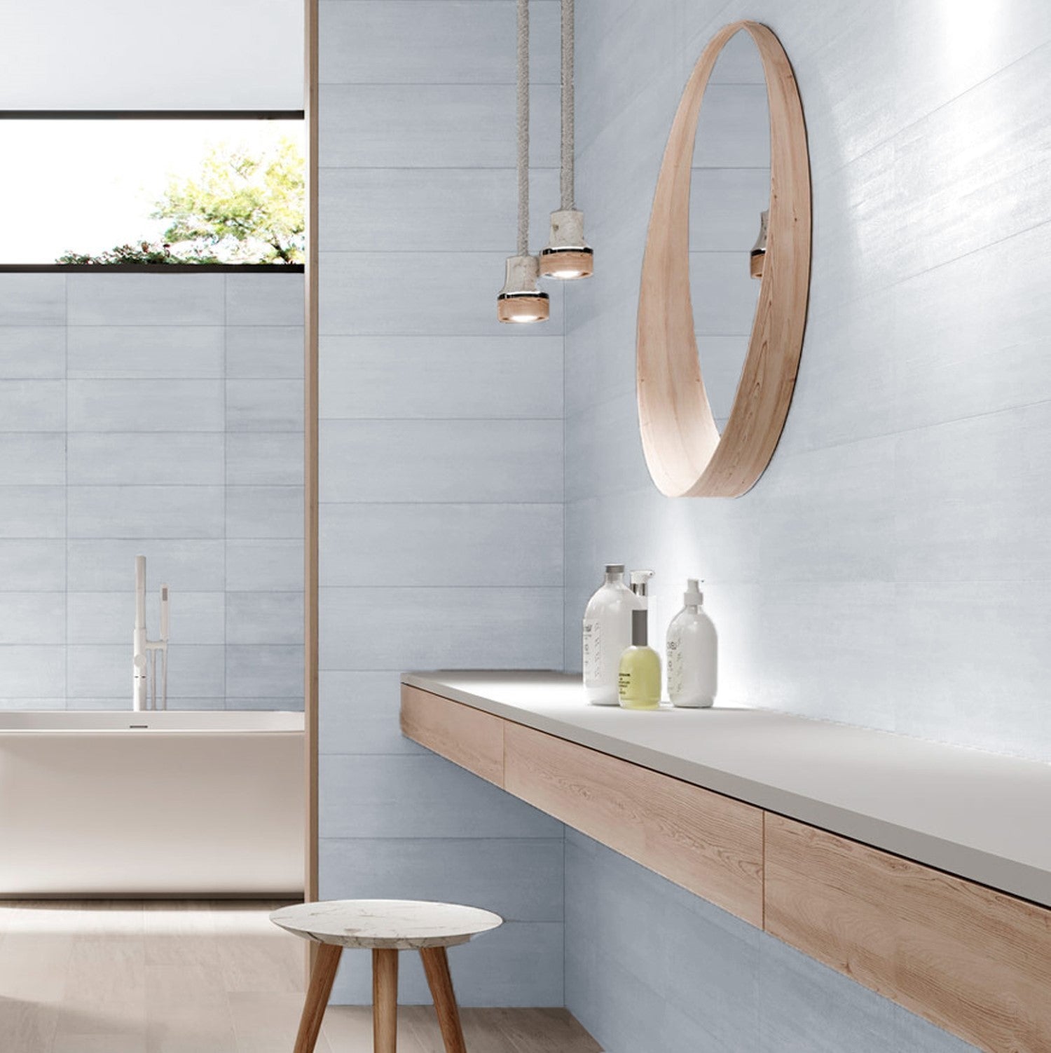 A bathroom setting featuring a blue soft brushed wall tiles, alongside a wooden vanity and mirror.