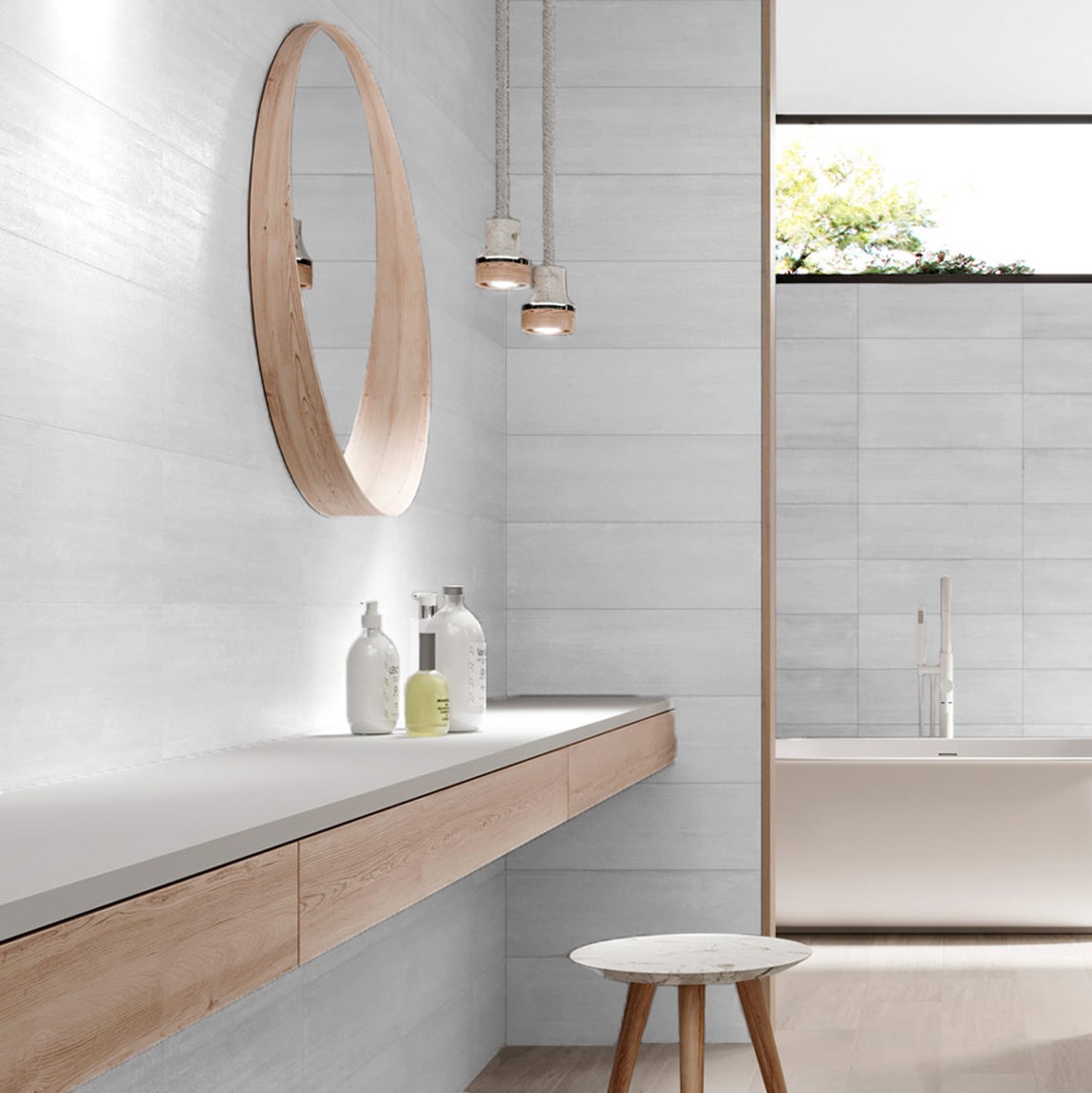 A bathroom setting featuring Strand Blanc white tiles on the wall, with a soft-brushed satin finish, muted green tone, and a contemporary aesthetic.