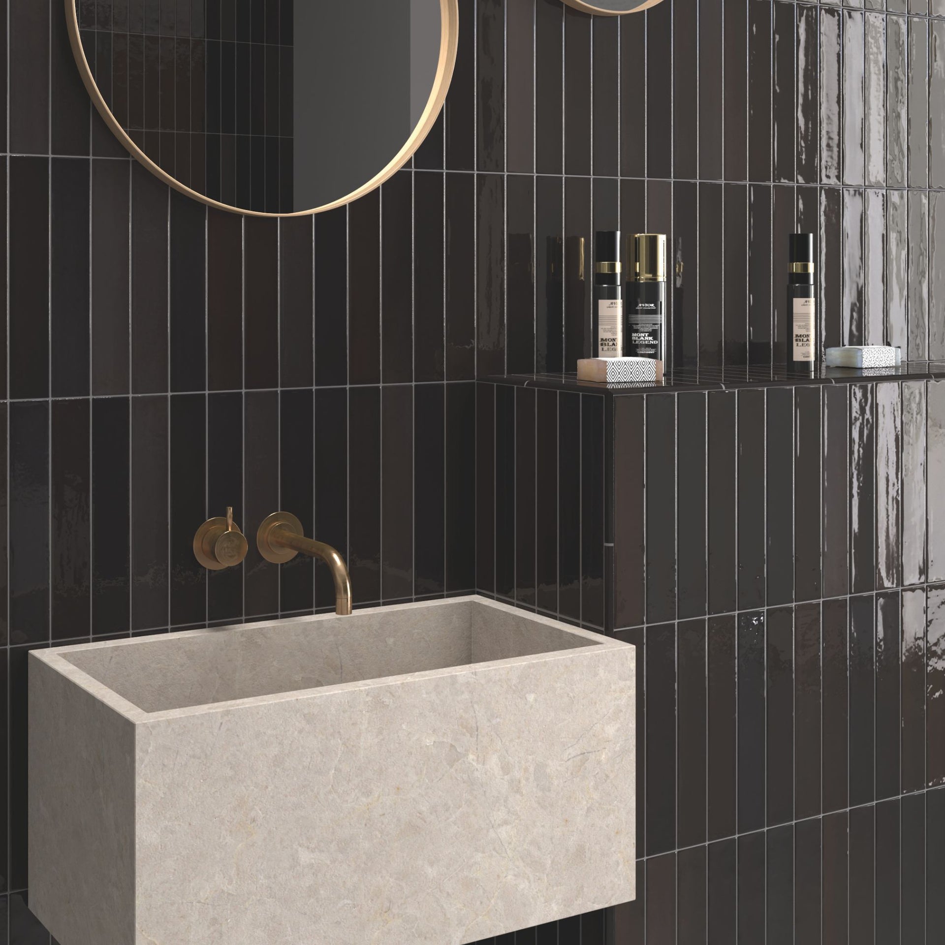 Bathroom with black tortosa gloss tiled tiled walls, a grey sink, and gold fixtures.
