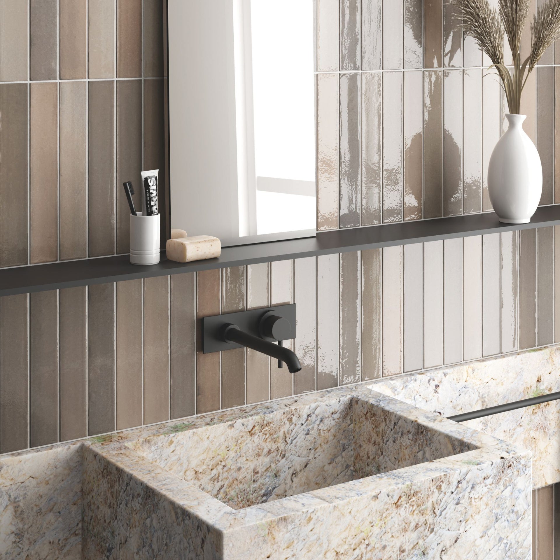Bathroom vanity with Tortosa Stone Grey glossy tonal artisan wall tiles, marble sink, black faucet, and decorative elements.

layout-bathroom