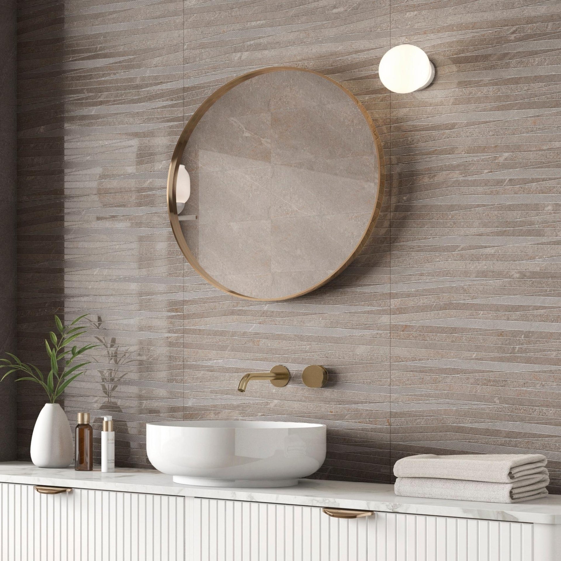Bathroom with round mirror, white sink, and taupe brown grey glossy wave decorative wall tiles