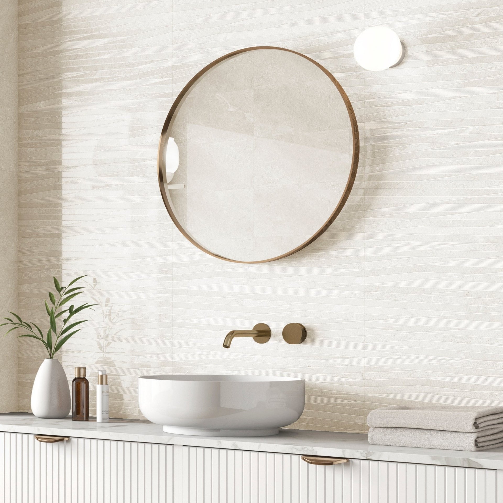 Bathroom with round mirror, sink, and decorative elements on a wave decor glossy tourmalet white wall.