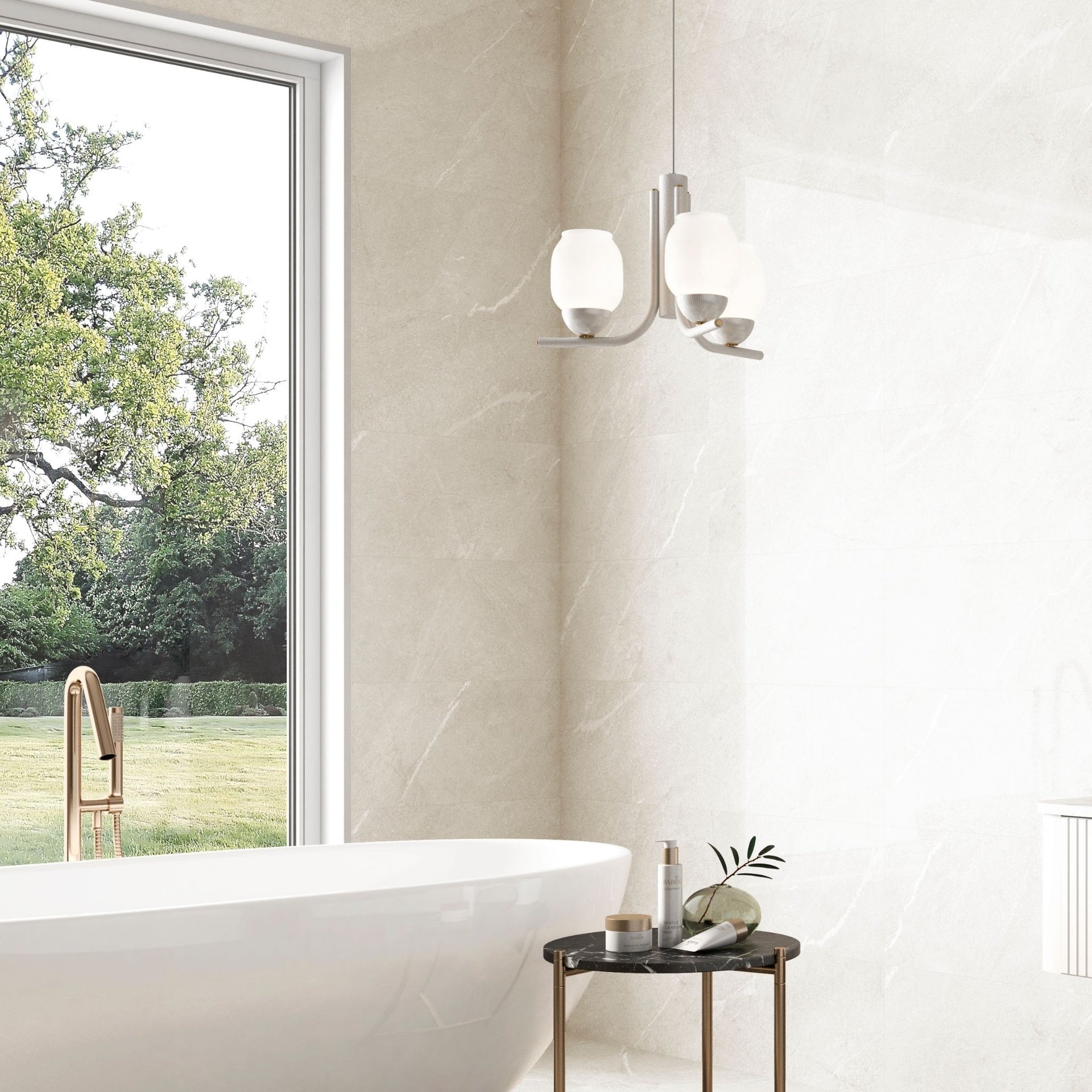 A glossy white stone effect wall tile with a natural limestone effect, shown installed in a bathroom setting with a bathtub, window with greenery, and a small table with toiletries in the foreground.